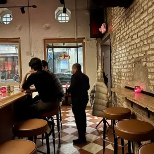 a group of people sitting at a bar