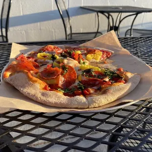 Pie w/ pepperoni, banana peppers, basil, and oregano.
