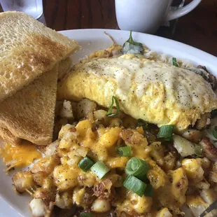Veggie omelet country fried with cheese and scallions.
