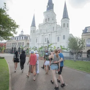 people walking in front of a cathedral