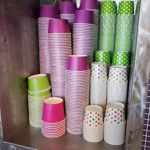a display of colorful cups