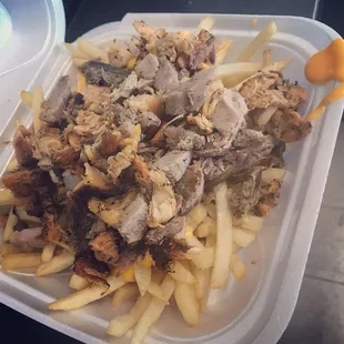Papas locas: chicken, pork and beef over fries, cheese and mayo ketchup.