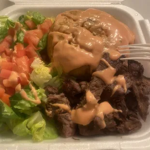 a mofongo with skirt steak, salad and Mayo Ketchup