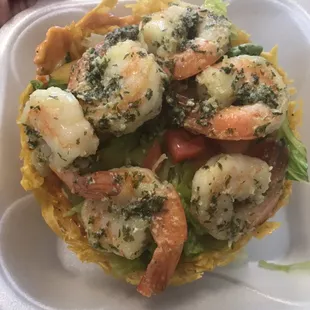 Our green plantain basket filled with delicious garlic shrimps.