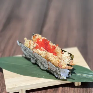 a piece of sushi on a leaf