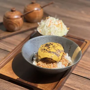 a bowl of food on a wooden tray