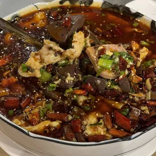a bowl of soup with meat and vegetables