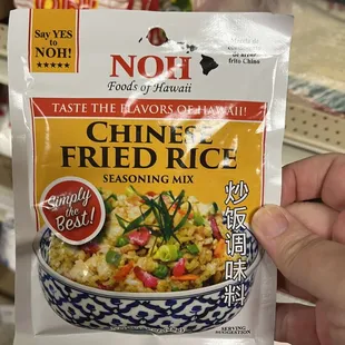 a hand holding a bag of chinese fried rice