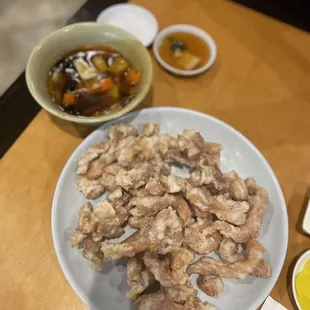 a plate of chicken wings with dipping sauces