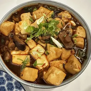 a bowl of tofu and mushrooms