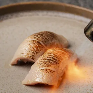 two pieces of sushi on a plate