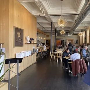 people sitting at tables in a restaurant