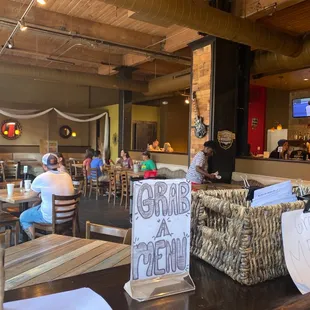 people sitting at tables in a restaurant