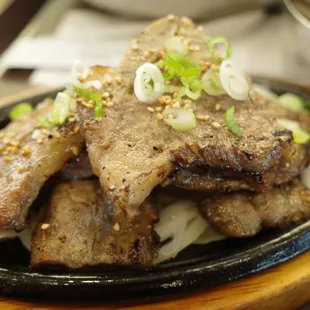 a plate of beef and noodles