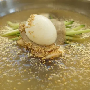 a boiled egg in a bowl of soup