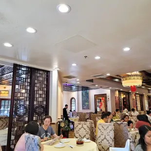 a group of people sitting at tables in a restaurant