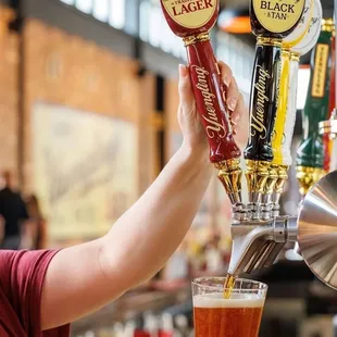 a person pouring a beer