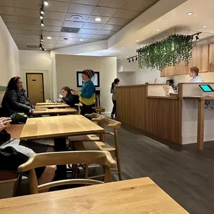 people sitting at tables in a restaurant