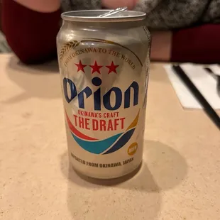 a woman sitting at a table with a drink in front of her