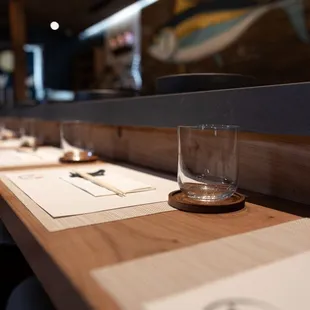 a row of empty glasses on a table