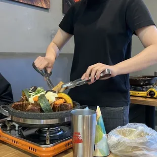 a woman in a face mask preparing food