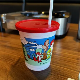 a plastic cup with a straw on a table
