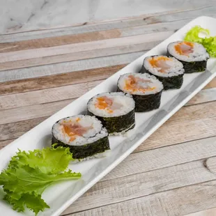 a plate of sushi on a wooden table