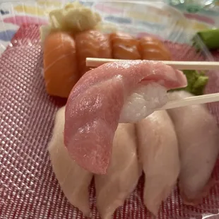 Toro nigiri with Hamachi and Salmon nigiri in the background. Also, a Topo Chico.
