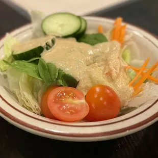 a plate of salad with dressing