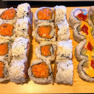 a variety of sushi rolls on a cutting board
