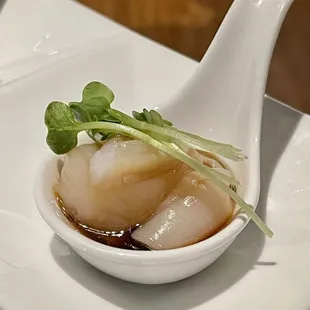 a small bowl of food on a white plate