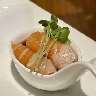 a bowl of sushi with a spoon