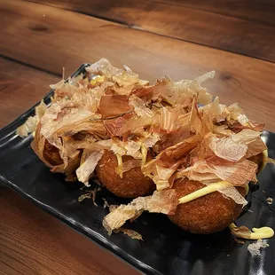 a plate of fried food on a wooden table