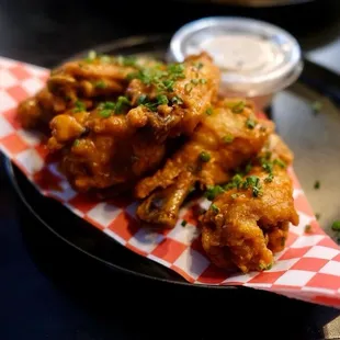 6 wings with buffalo sauce and a side of vegan ranch.