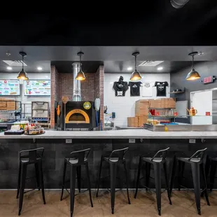 Main bar and seating area with view of pizza making and wood fired oven!