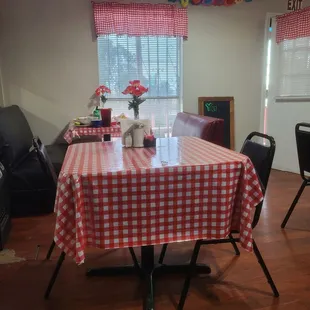 a table with a red and white checkered tablecloth
