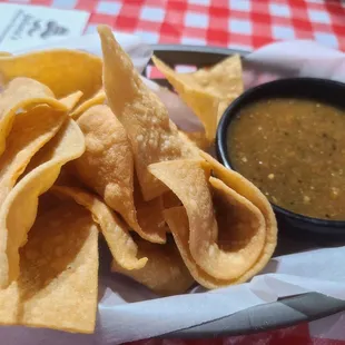 a basket of chips and a bowl of salsa