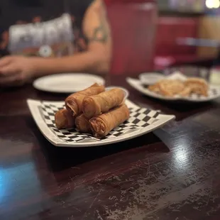 a man sitting at a table with plates of food