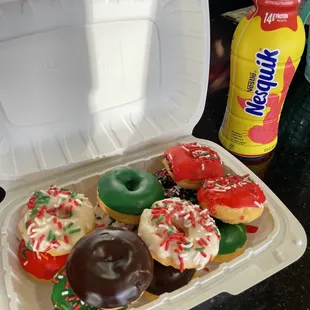 a variety of donuts in a styrofoam container