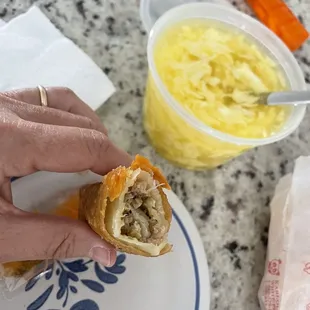 a person holding a sandwich