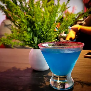 a blue drink in a tall glass