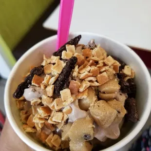 a hand holding a cup of ice cream