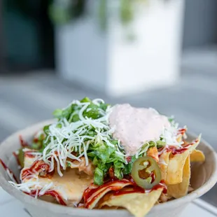 a bowl of nachos on a table