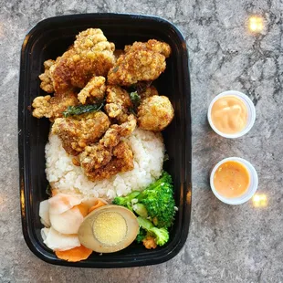 Fried chicken bento box with spicy mayo (top) and sweet chili (bottom) sauce on the side