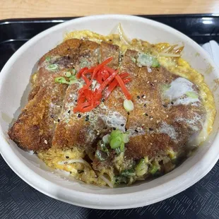 Katsudon Pork Cutlet.  Tasty pork cutlet, egg, onion, and sweet soy sauce over rice.
