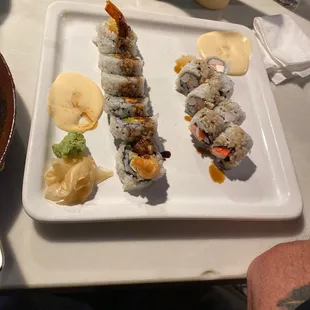 a plate of sushi and a bowl of sauce