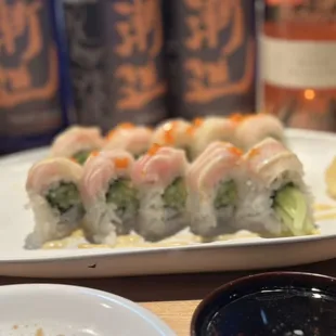 a plate of sushi and chopsticks
