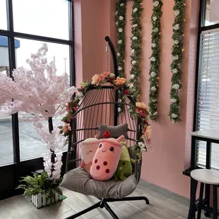 a hanging chair with a stuffed animal