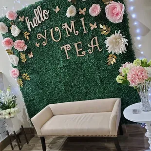 a wall of flowers and a bench