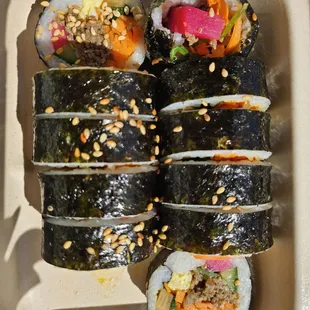 sushi rolls in a styrofoam container